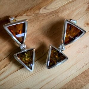 Two tones of amber with inclusions set in sterling silver.